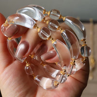 Moonlit Clear Quartz Crystal Bracelet featuring genuine moon-shaped clear quartz crystals, polished round quartz beads, and gold vermeil separation beads in a handcrafted floral-inspired design.