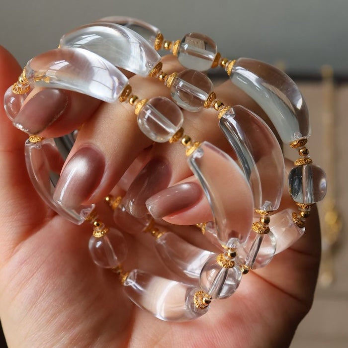 Moonlit Clear Quartz Crystal Bracelet featuring genuine moon-shaped clear quartz crystals, polished round quartz beads, and gold vermeil separation beads in a handcrafted floral-inspired design.