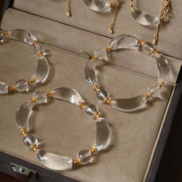 Moonlit Clear Quartz Crystal Bracelet featuring genuine moon-shaped clear quartz crystals, polished round quartz beads, and gold vermeil separation beads in a handcrafted floral-inspired design.