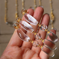 Moonlit Clear Quartz Crystal Bracelet featuring genuine moon-shaped clear quartz crystals, polished round quartz beads, and gold vermeil separation beads in a handcrafted floral-inspired design.