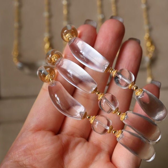 Moonlit Clear Quartz Crystal Bracelet featuring genuine moon-shaped clear quartz crystals, polished round quartz beads, and gold vermeil separation beads in a handcrafted floral-inspired design.