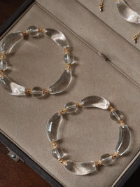Moonlit Clear Quartz Crystal Bracelet featuring genuine moon-shaped clear quartz crystals, polished round quartz beads, and gold vermeil separation beads in a handcrafted floral-inspired design.