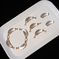 Moonlit Clear Quartz Crystal Bracelet featuring genuine moon-shaped clear quartz crystals, polished round quartz beads, and gold vermeil separation beads in a handcrafted floral-inspired design.