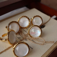 Vintage Mother of Pearl Dome Ring featuring a large round mother-of-pearl cabochon in a textured gold-tone adjustable setting worn as a statement ring.
