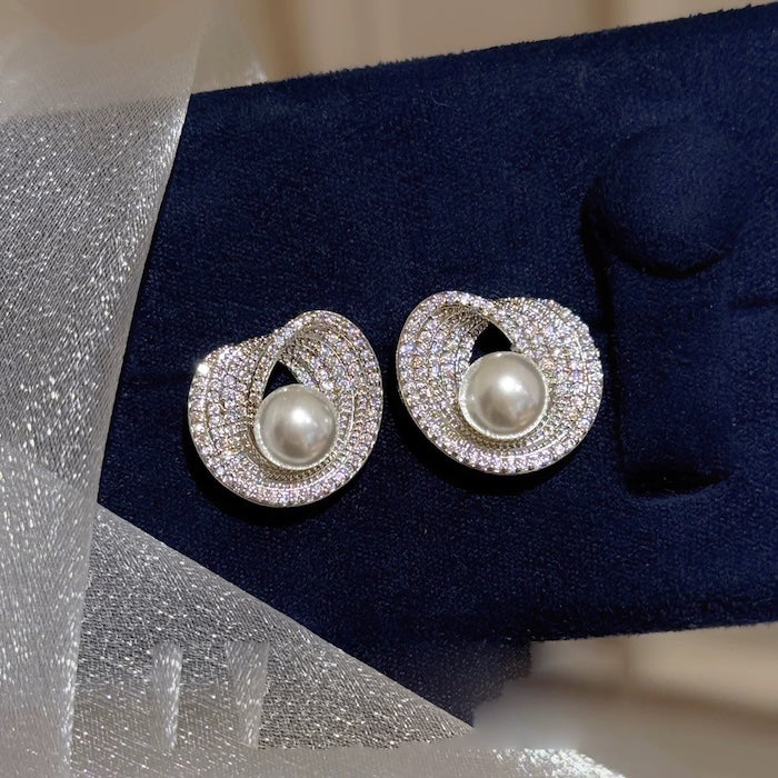 Radiant Pearl Halo Stud Earrings in silver-plated brass featuring a simulated pearl surrounded by a sparkling cubic zirconia halo.