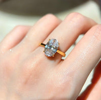 Dazzling 5CT Pigeon Egg Oval Stone Ring featuring a large oval-cut premium zirconia in a gold-plated adjustable solitaire-inspired setting.
