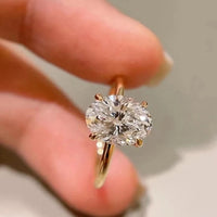 Dazzling 5CT Pigeon Egg Oval Stone Ring featuring a large oval-cut premium zirconia in a gold-plated adjustable solitaire-inspired setting.

