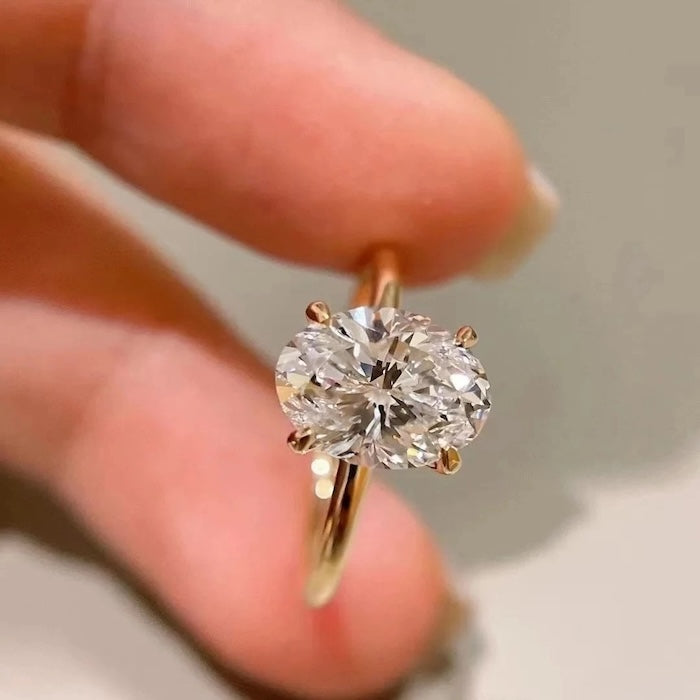 Dazzling 5CT Pigeon Egg Oval Stone Ring featuring a large oval-cut premium zirconia in a gold-plated adjustable solitaire-inspired setting.
