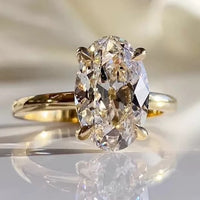 Dazzling 5CT Pigeon Egg Oval Stone Ring featuring a large oval-cut premium zirconia in a gold-plated adjustable solitaire-inspired setting.
