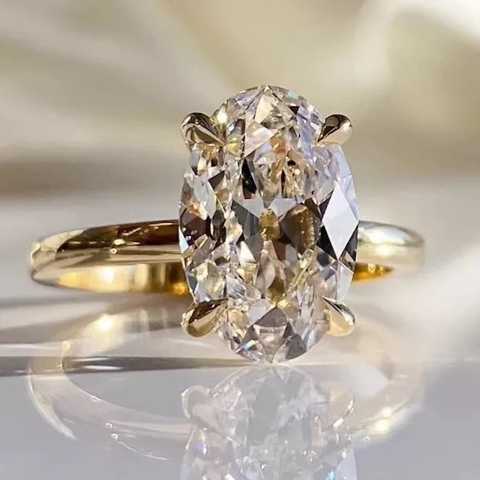 Dazzling 5CT Pigeon Egg Oval Stone Ring featuring a large oval-cut premium zirconia in a gold-plated adjustable solitaire-inspired setting.
