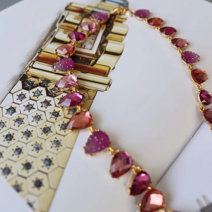 Chunky Vintage Pink Crystal Statement Necklace featuring sparkling pink crystal drop beads and matte gold plated details in a vintage-inspired statement design.
