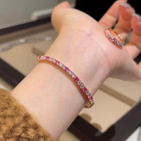 Dazzling Pink Ombré Tennis Bracelet featuring sparkling pink and clear zirconias in a gradient tennis bracelet design, available in two stone sizes.

