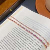 Dazzling Pink Ombré Tennis Bracelet featuring sparkling pink and clear zirconias in a gradient tennis bracelet design, available in two stone sizes.

