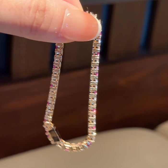 Dazzling Pink Ombré Tennis Bracelet featuring sparkling pink and clear zirconias in a gradient tennis bracelet design, available in two stone sizes.
