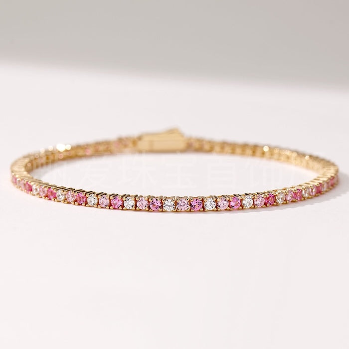 Dazzling Pink Ombré Tennis Bracelet featuring sparkling pink and clear zirconias in a gradient tennis bracelet design, available in two stone sizes.
