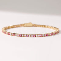 Dazzling Pink Ombré Tennis Bracelet featuring sparkling pink and clear zirconias in a gradient tennis bracelet design, available in two stone sizes.
