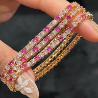 Dazzling Pink Ombré Tennis Bracelet featuring sparkling pink and clear zirconias in a gradient tennis bracelet design, available in two stone sizes.
