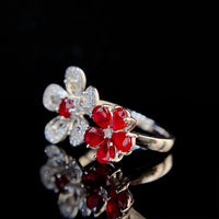 Ruby Plum Blossom Ring featuring ruby-colored and clear crystal plum blossoms on a white gold-plated adjustable band.