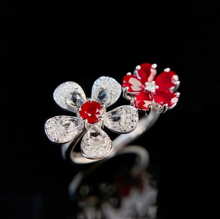 Ruby Plum Blossom Ring featuring ruby-colored and clear crystal plum blossoms on a white gold-plated adjustable band.