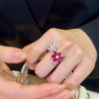 Ruby Plum Blossom Ring featuring ruby-colored and clear crystal plum blossoms on a white gold-plated adjustable band.