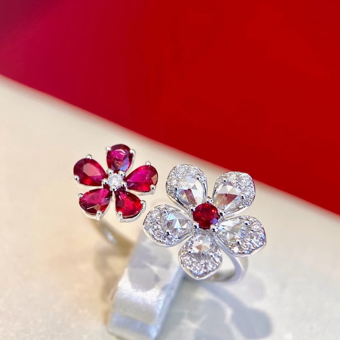 Ruby Plum Blossom Ring featuring ruby-colored and clear crystal plum blossoms on a white gold-plated adjustable band.