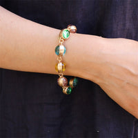 Vintage Rainbow Glass Stones Jewelry Set featuring multicolor glass stones in green, blue, pink, and amber tones linked in a gold-tone vintage-inspired necklace and bracelet design.
