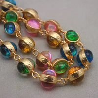 Vintage Rainbow Glass Stones Jewelry Set featuring multicolor glass stones in green, blue, pink, and amber tones linked in a gold-tone vintage-inspired necklace and bracelet design.
