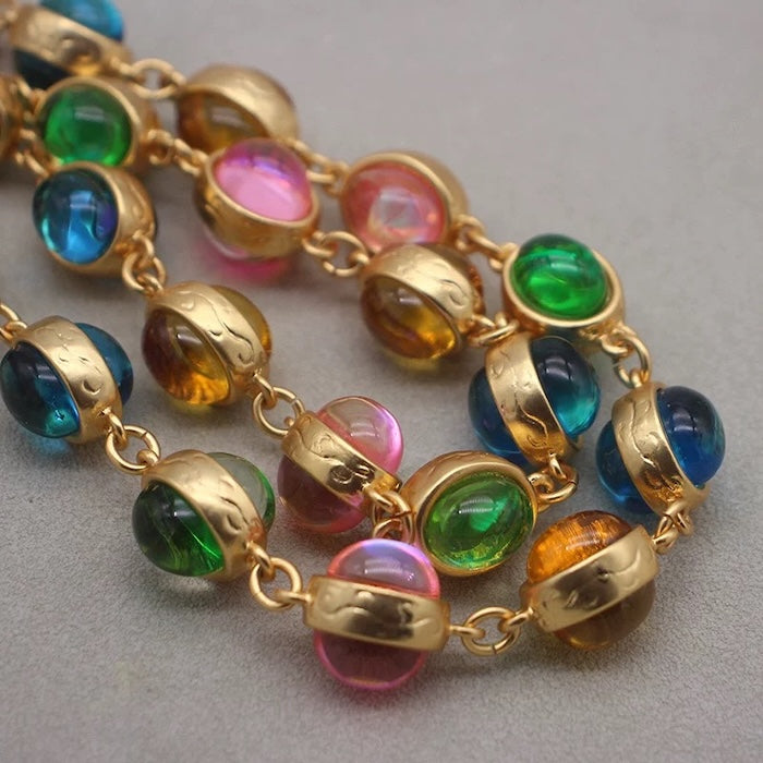 Vintage Rainbow Glass Stones Jewelry Set featuring multicolor glass stones in green, blue, pink, and amber tones linked in a gold-tone vintage-inspired necklace and bracelet design.

