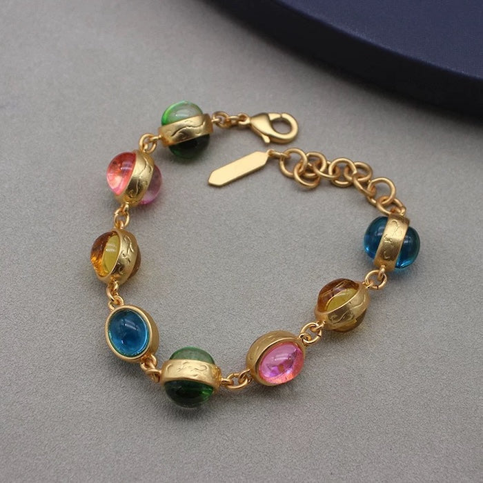 Vintage Rainbow Glass Stones Jewelry Set featuring multicolor glass stones in green, blue, pink, and amber tones linked in a gold-tone vintage-inspired necklace and bracelet design.

