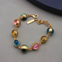 Vintage Rainbow Glass Stones Jewelry Set featuring multicolor glass stones in green, blue, pink, and amber tones linked in a gold-tone vintage-inspired necklace and bracelet design.
