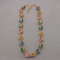 Vintage Rainbow Glass Stones Jewelry Set featuring multicolor glass stones in green, blue, pink, and amber tones linked in a gold-tone vintage-inspired necklace and bracelet design.
