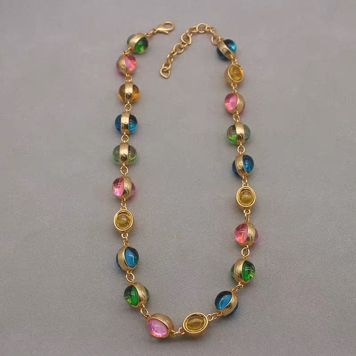 Vintage Rainbow Glass Stones Jewelry Set featuring multicolor glass stones in green, blue, pink, and amber tones linked in a gold-tone vintage-inspired necklace and bracelet design.
