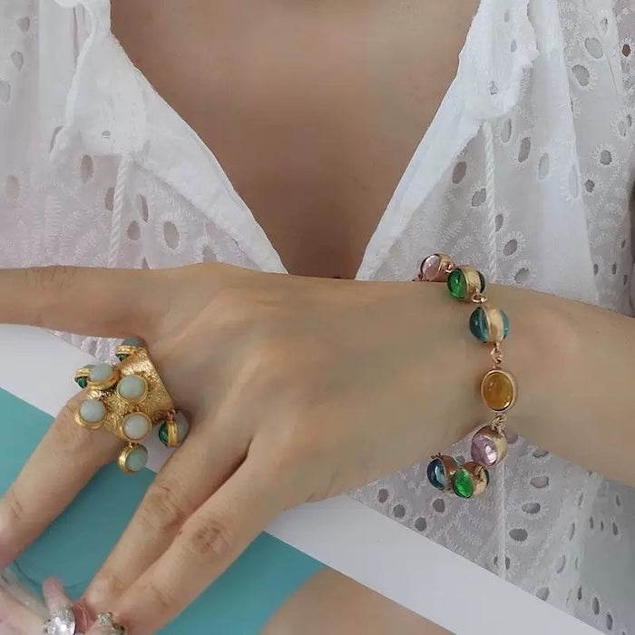 Vintage Rainbow Glass Stones Jewelry Set featuring multicolor glass stones in green, blue, pink, and amber tones linked in a gold-tone vintage-inspired necklace and bracelet design.
