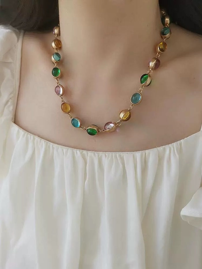 Vintage Rainbow Glass Stones Jewelry Set featuring multicolor glass stones in green, blue, pink, and amber tones linked in a gold-tone vintage-inspired necklace and bracelet design.
