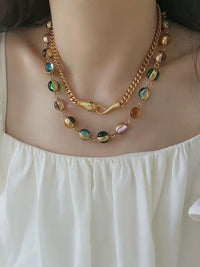 Vintage Rainbow Glass Stones Jewelry Set featuring multicolor glass stones in green, blue, pink, and amber tones linked in a gold-tone vintage-inspired necklace and bracelet design.
