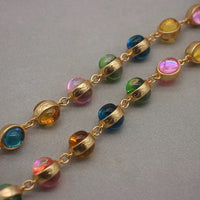 Vintage Rainbow Glass Stones Jewelry Set featuring multicolor glass stones in green, blue, pink, and amber tones linked in a gold-tone vintage-inspired necklace and bracelet design.
