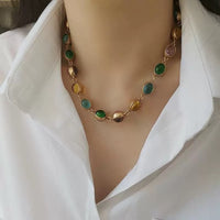 Vintage Rainbow Glass Stones Jewelry Set featuring multicolor glass stones in green, blue, pink, and amber tones linked in a gold-tone vintage-inspired necklace and bracelet design.
