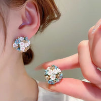 Blooming Rose Bouquet Ceramic Earrings featuring handcrafted ceramic roses, sparkling crystal accents, and rose gold-plated brass. Available in lilac or light blue for timeless vintage-inspired elegance.