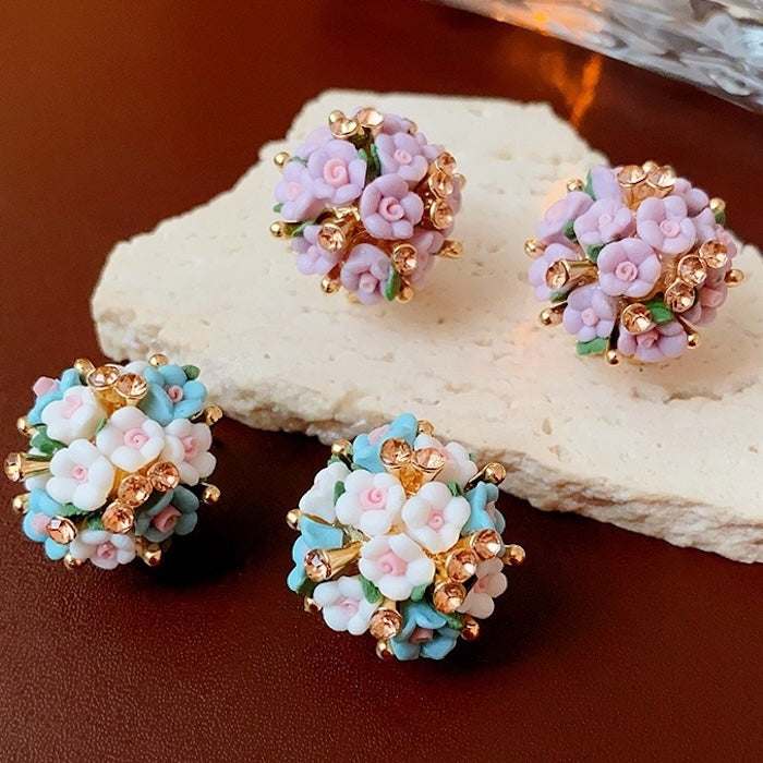 Blooming Rose Bouquet Ceramic Earrings featuring handcrafted ceramic roses, sparkling crystal accents, and rose gold-plated brass. Available in lilac or light blue for timeless vintage-inspired elegance.