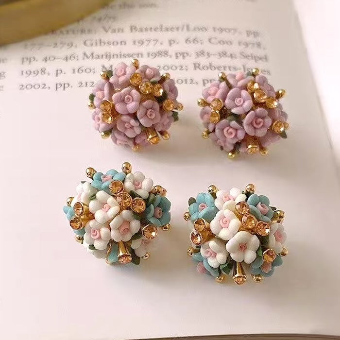 Blooming Rose Bouquet Ceramic Earrings featuring handcrafted ceramic roses, sparkling crystal accents, and rose gold-plated brass. Available in lilac or light blue for timeless vintage-inspired elegance.