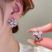 Blooming Rose Bouquet Ceramic Earrings featuring handcrafted ceramic roses, sparkling crystal accents, and rose gold-plated brass. Available in lilac or light blue for timeless vintage-inspired elegance.