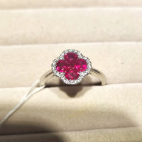 Vivid Ruby Flower Jewelry Set featuring ruby-red floral zirconias surrounded by sparkling crystal halos, including matching stud earrings and an adjustable ring.
