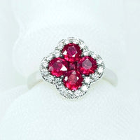 Vivid Ruby Flower Jewelry Set featuring ruby-red floral zirconias surrounded by sparkling crystal halos, including matching stud earrings and an adjustable ring.
