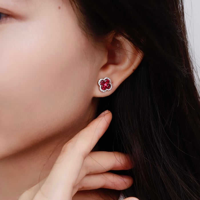 Vivid Ruby Flower Jewelry Set featuring ruby-red floral zirconias surrounded by sparkling crystal halos, including matching stud earrings and an adjustable ring.
