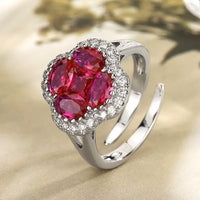 Vivid Ruby Flower Jewelry Set featuring ruby-red floral zirconias surrounded by sparkling crystal halos, including matching stud earrings and an adjustable ring.
