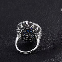 Royal Sapphire Halo Crystal Dress Ring in white gold-plated brass featuring a sapphire-blue center crystal with layered blue and clear crystal halos.
