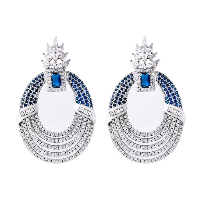 Royal Style Sapphire Look Oversized Earrings featuring sapphire-blue zirconias, sparkling pavé crystal details, and an elegant silver-tone statement design.
