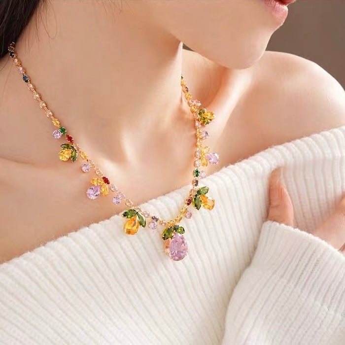 Secret Garden Crystal Jewelry Set featuring gold-plated brass with premium pink, green, yellow, and clear zirconia crystals in a botanical-inspired necklace and matching drop earrings.