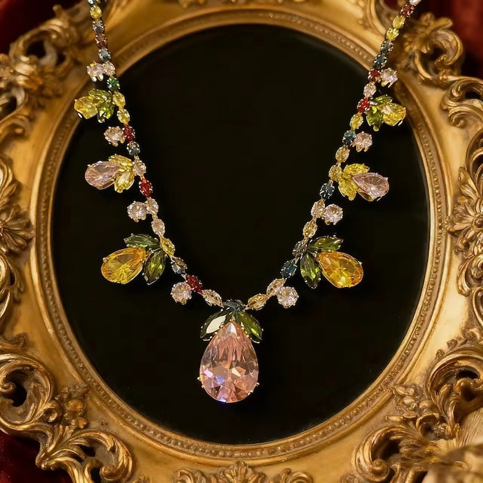 Secret Garden Crystal Jewelry Set featuring gold-plated brass with premium pink, green, yellow, and clear zirconia crystals in a botanical-inspired necklace and matching drop earrings.