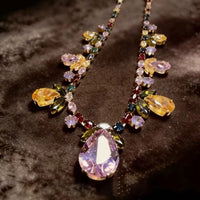 Secret Garden Crystal Jewelry Set featuring gold-plated brass with premium pink, green, yellow, and clear zirconia crystals in a botanical-inspired necklace and matching drop earrings.